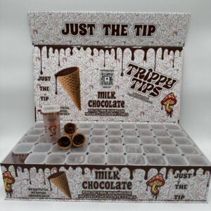 A stylish and eye-catching box labeled 'Trippy Tips Milk Chocolate Penis Envy Shrooms Cone Master Box,' showcasing pre-rolled cones filled with Penis Envy mushrooms and milk chocolate. The packaging highlights the product's blend of rich flavor and potent psychedelic effects