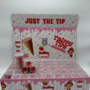 A sleek and colorful box labeled 'Trippy Tips Strawberry Avery Albino,' showcasing pre-rolled cones filled with Avery Albino mushrooms and strawberry flavor. The cones and packaging emphasize the product’s convenience, quality, and unique flavor combination