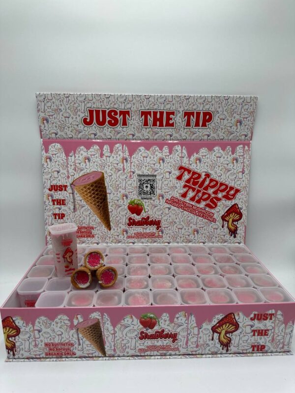 A sleek and colorful box labeled 'Trippy Tips Strawberry Avery Albino,' showcasing pre-rolled cones filled with Avery Albino mushrooms and strawberry flavor. The cones and packaging emphasize the product’s convenience, quality, and unique flavor combination